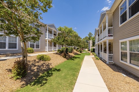 A sunny day at a residential complex with a clear blue sky.