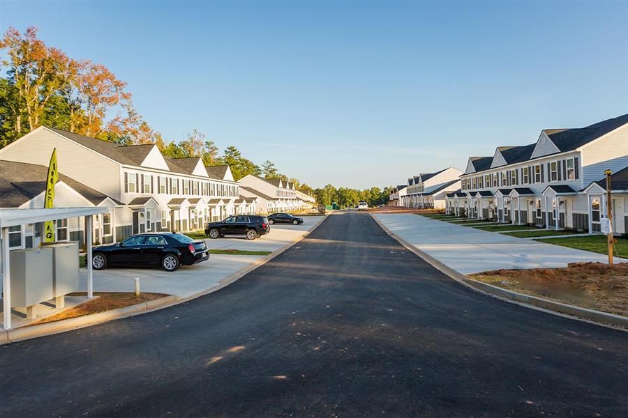 a street with cars parked in front of houses