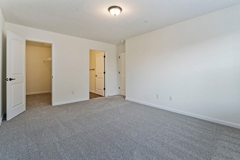A room with carpeted floor and white walls.