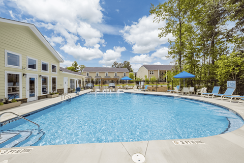 A large swimming pool with a slide in the middle of a resort.