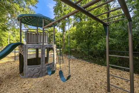 A playground with a slide and swings.