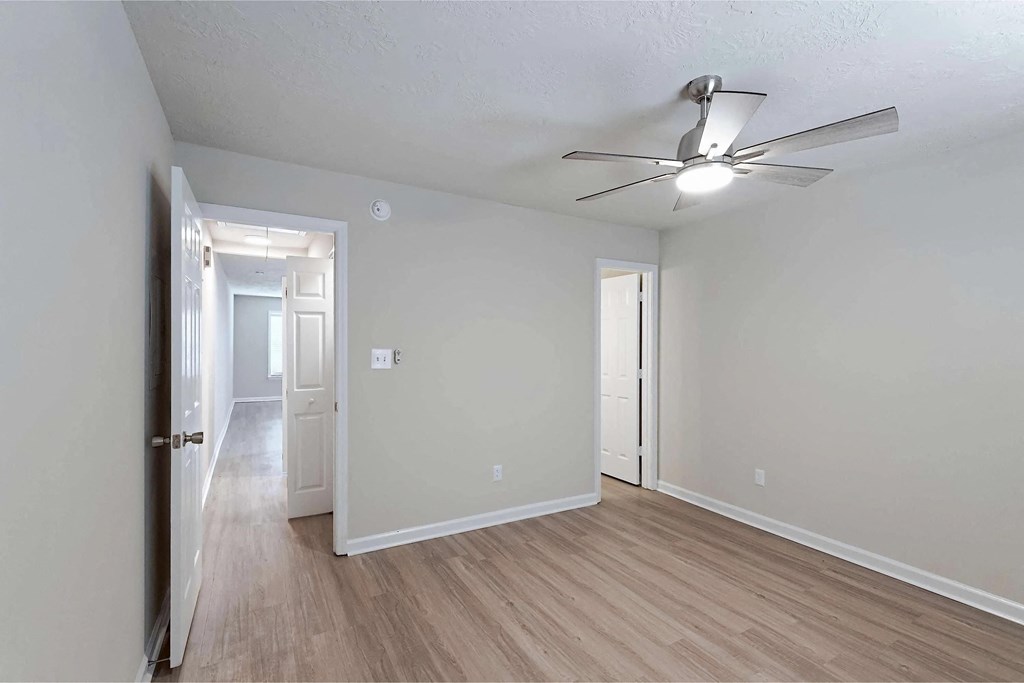 Bedroom with LVT flooring and ceiling fan