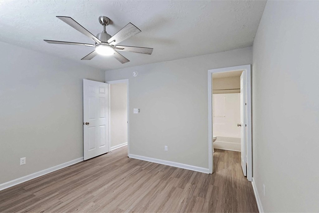 Bedroom leading to bathroom and hallway