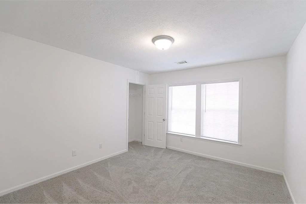 Bedroom with carpet and closet