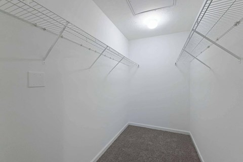 a spacious closet in a white room with white walls and a white walled closet at Sterlington Apartments, Georgia