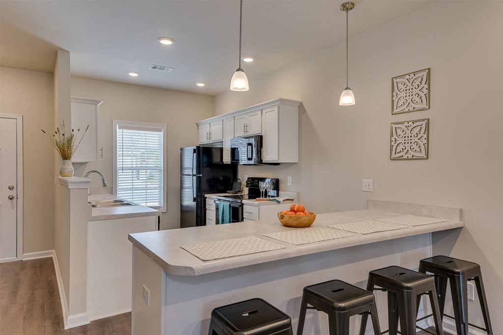a kitchen with a counter top and stools
