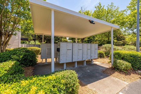 A white covered pavement with a row of mailboxes.