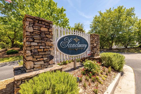 A sign that says "Candleberry" is mounted on a stone pillar.