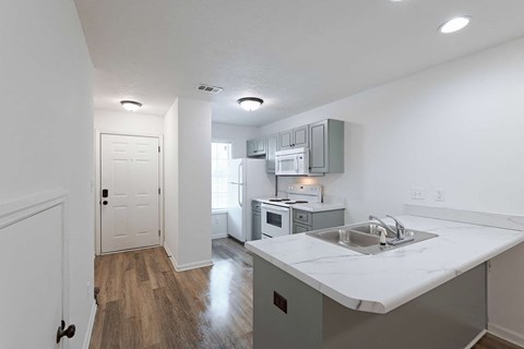 a kitchen with white counter tops and a sink