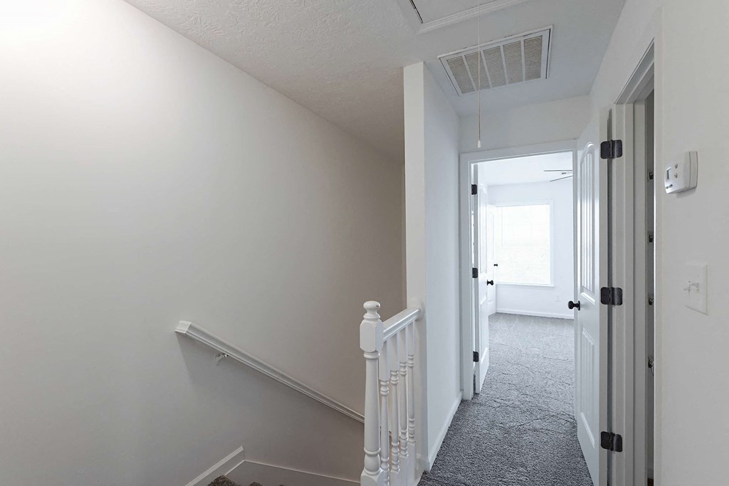 Carpet throughout the upstairs hallway leading into a bedroom at Sterlington Apartments, Grovetown, GA
