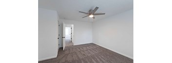Carpeted bedroom with ceiling fan