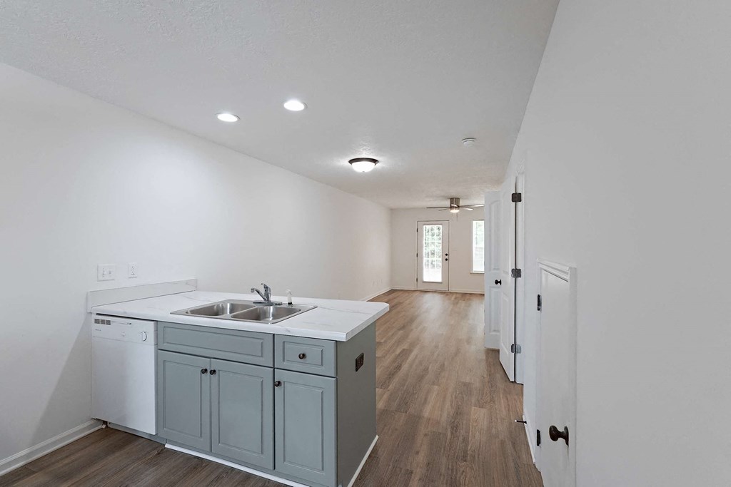 Kitchen area and living room with hardwood-style flooring throughout at Sterlington Apartments, Grovetown, GA