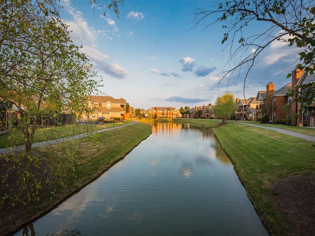 a river running through a neighborhood with houses