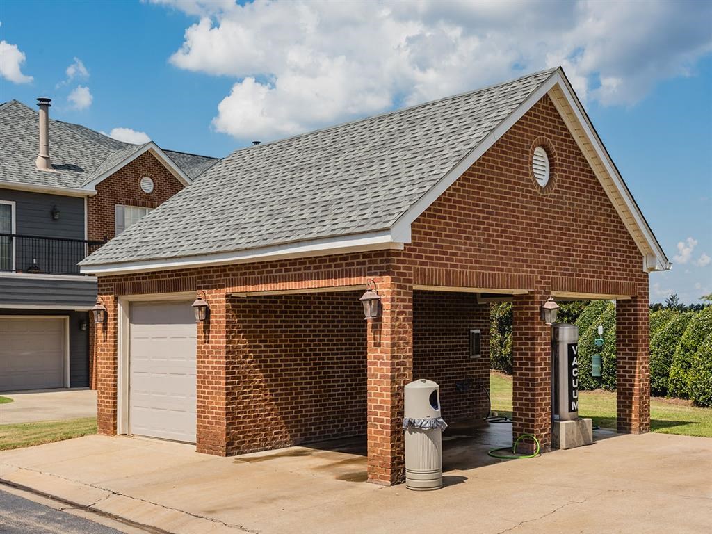 a brick garage with a fire hydrant in front of a house