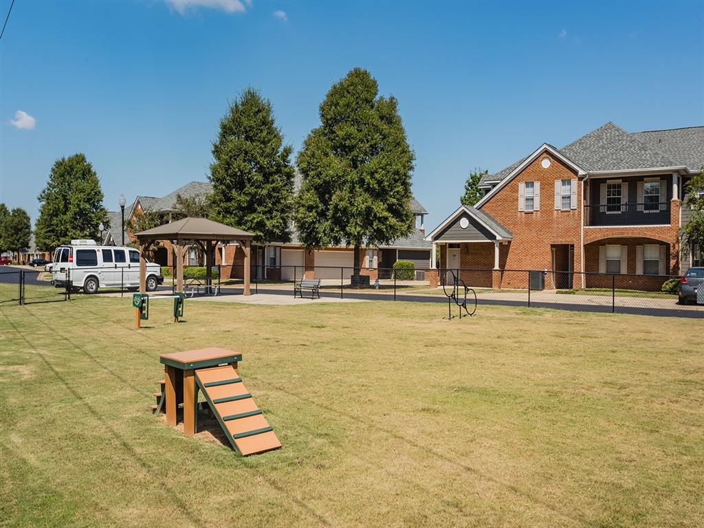a picnic table in a park in front of a house