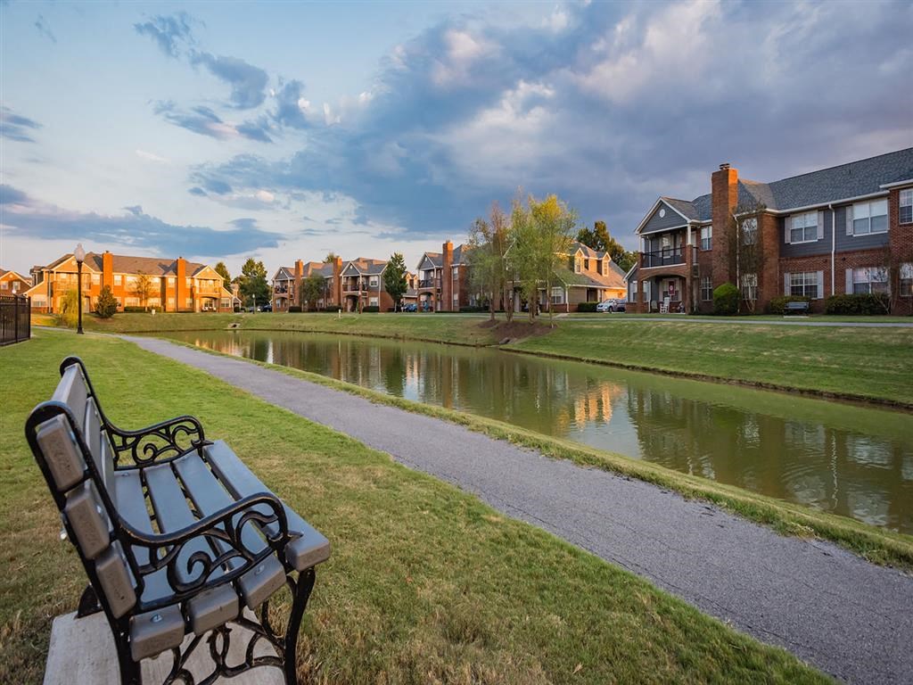 a park bench sitting next to a body of water
