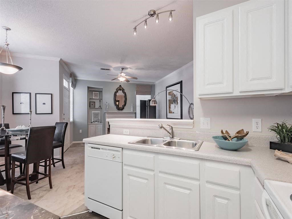 an open kitchen and dining room with a table and chairs