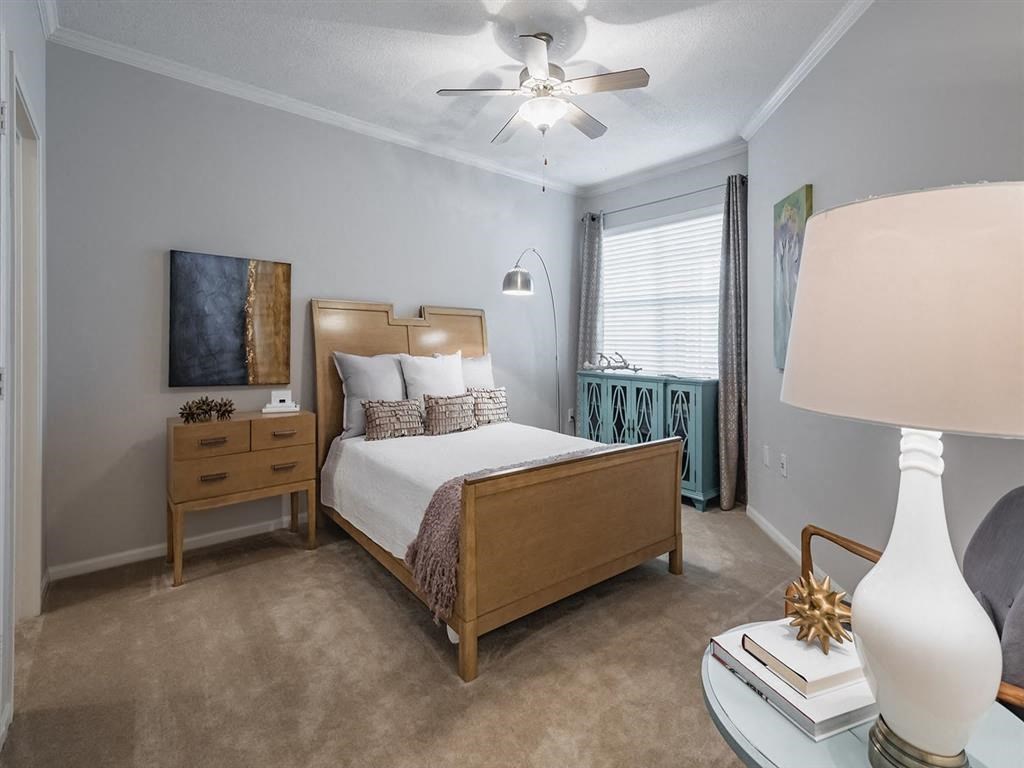 a bedroom with a bed and a ceiling fan