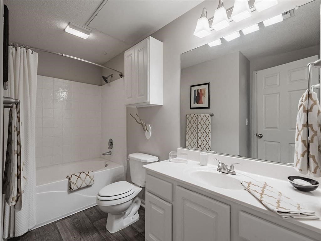 a white bathroom with a sink and a toilet