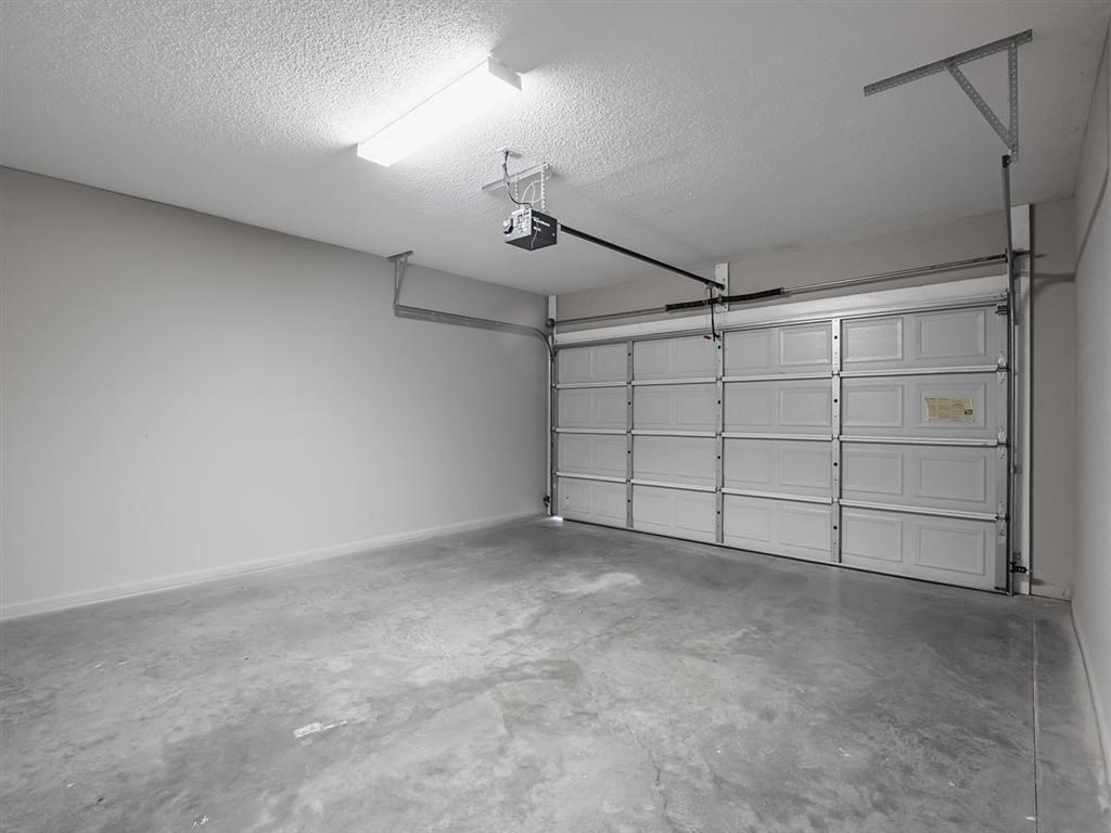 an empty garage with white walls and a garage door