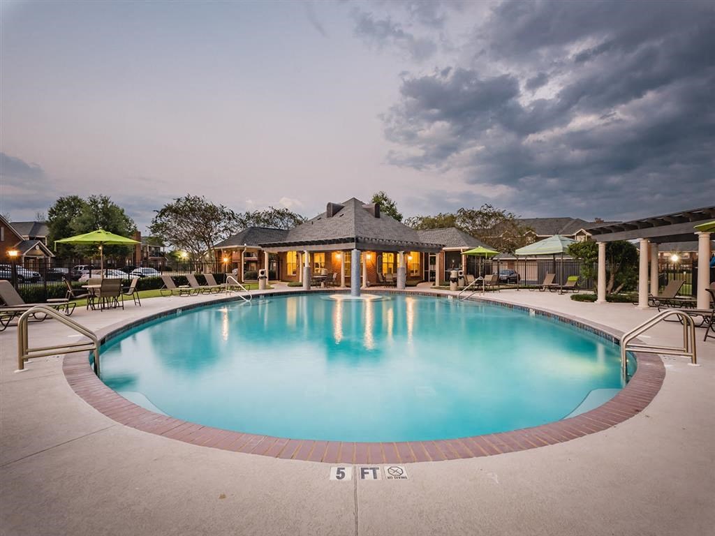 a large blue swimming pool with a building in the background