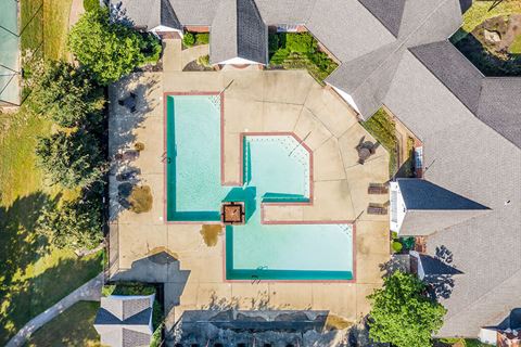 arial view of a swimming pool and a house with a pool