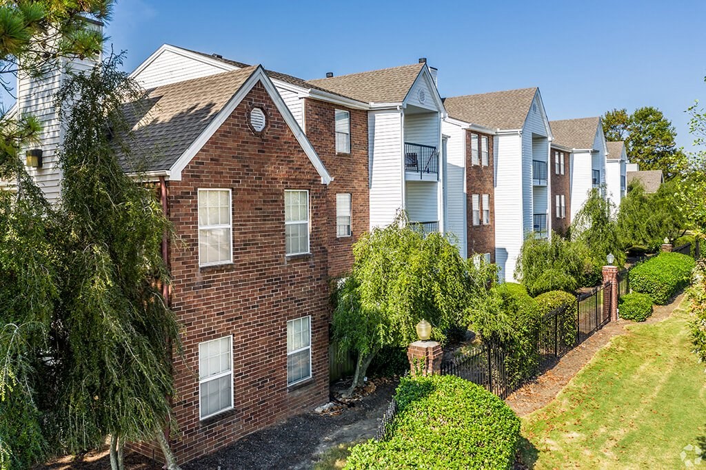 a brick house with a yard in front of it