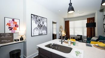A kitchen with a white counter top and a black chair at The Collective NoDa, Charlotte