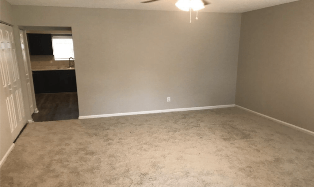 A room with a ceiling fan and carpeted floor at Diamond Townhomes, South Carolina