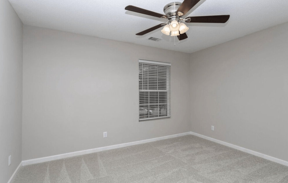 A room with a ceiling fan and a window with blinds at Diamond Townhomes, Beaufort, South Carolina