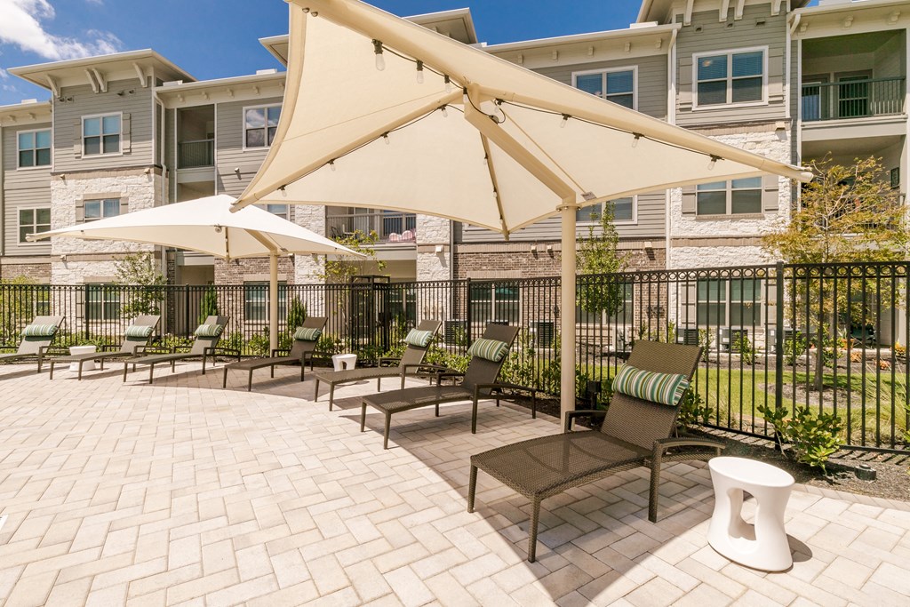 Poolside Relaxing Chairs at Cue Luxury Apartments, Texas