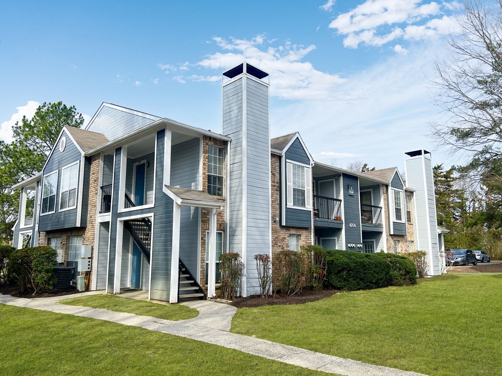 A modern two-story house with a chimney on the right side.