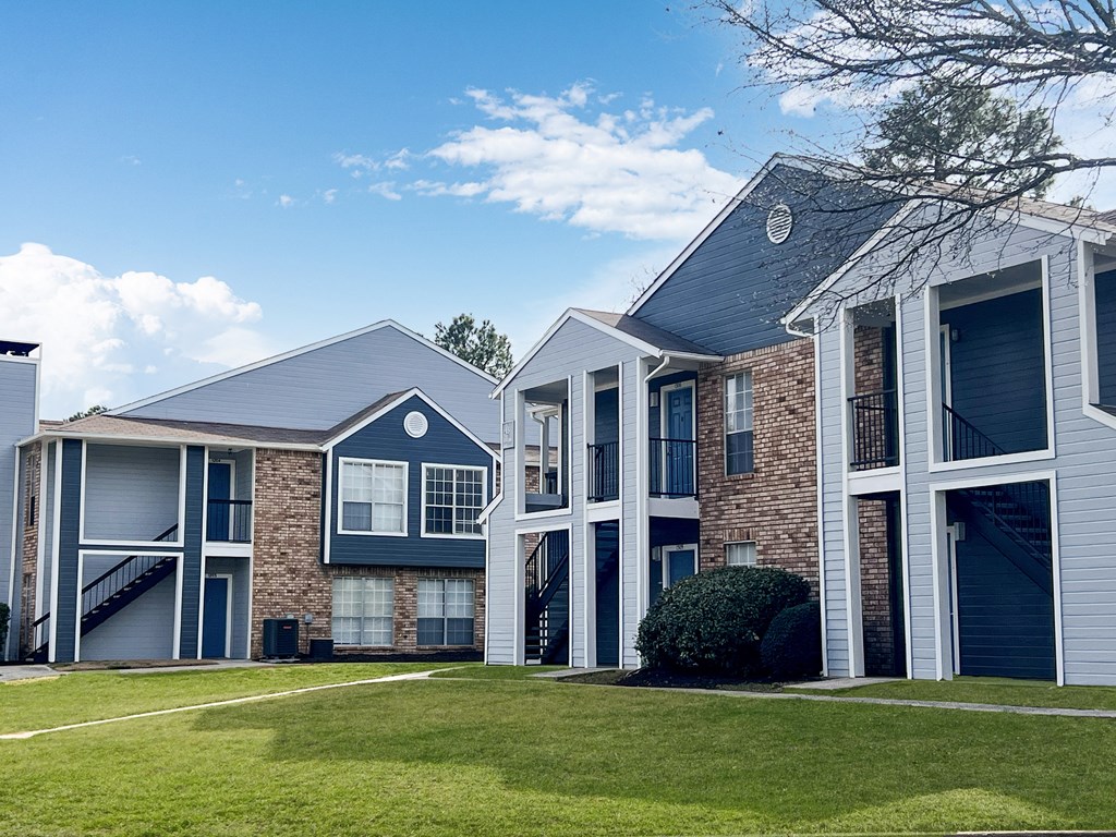 A row of houses with a blue sky in the background.