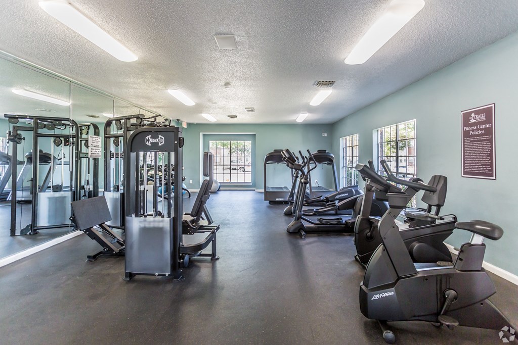 a gym with cardio machines and other exercise equipment