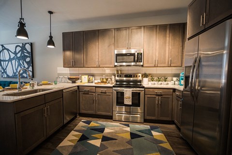a kitchen with stainless steel appliances and wooden cabinets