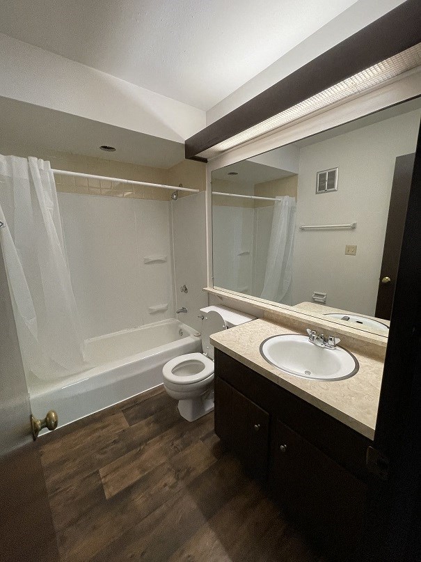 a bathroom with a toilet and a sink and a shower