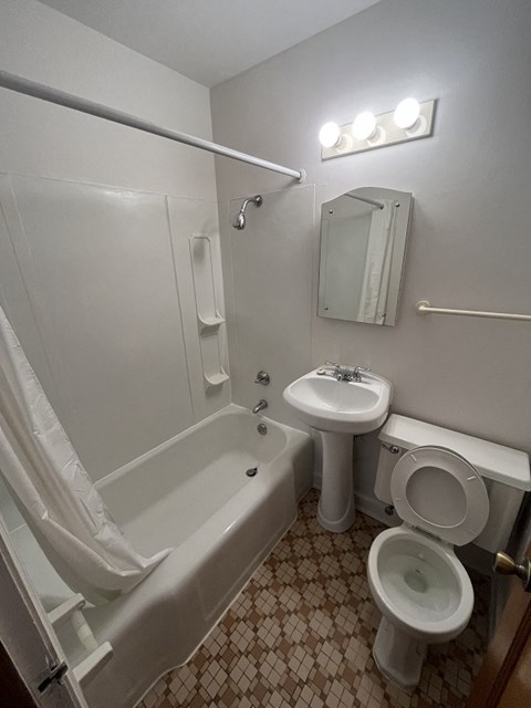 a bathroom with a sink toilet and a bath tub