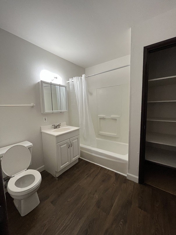 a bathroom with a toilet and a sink and a shower