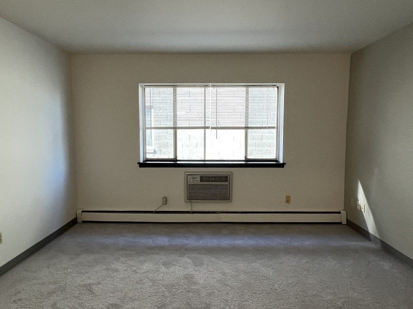the living room of an empty house with a window