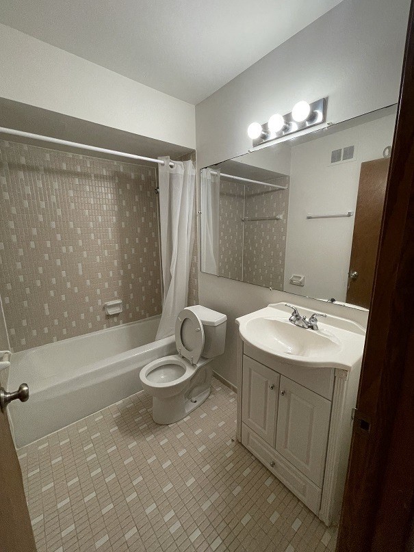 a bathroom with a toilet and a sink and a bath tub