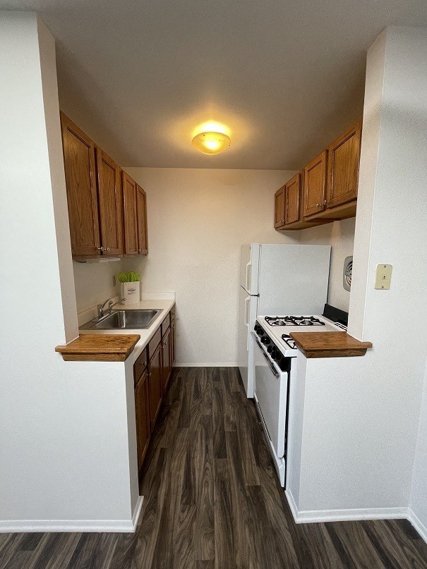 a small kitchen with a stove and a refrigerator