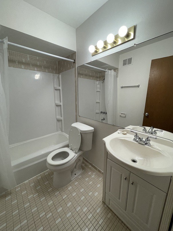 a bathroom with a toilet and a sink and a bath tub