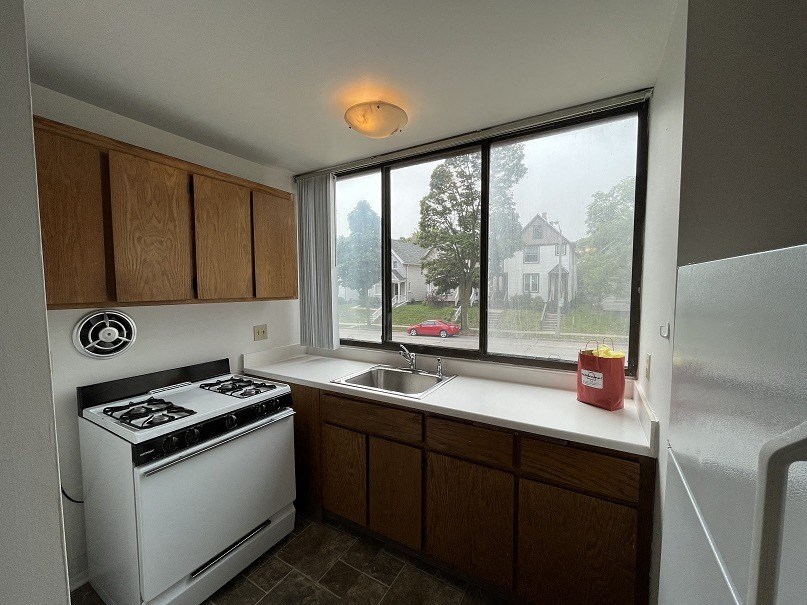 a kitchen with a stove sink and a window