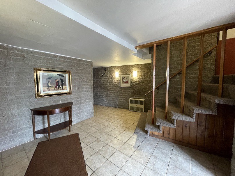 the lobby of a house with a staircase and a table