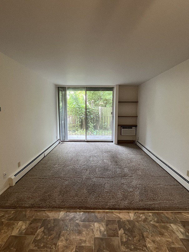 an empty living room with a sliding glass door