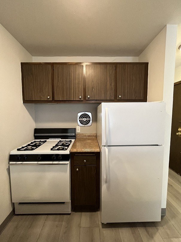 a kitchen with a stove and a refrigerator