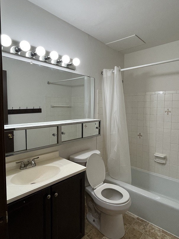 a bathroom with a toilet and a sink and a shower