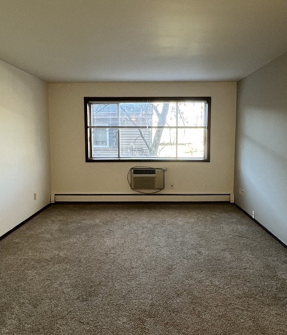 the living room of an empty house with a window