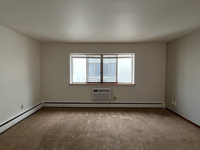 the living room of an empty house with a window