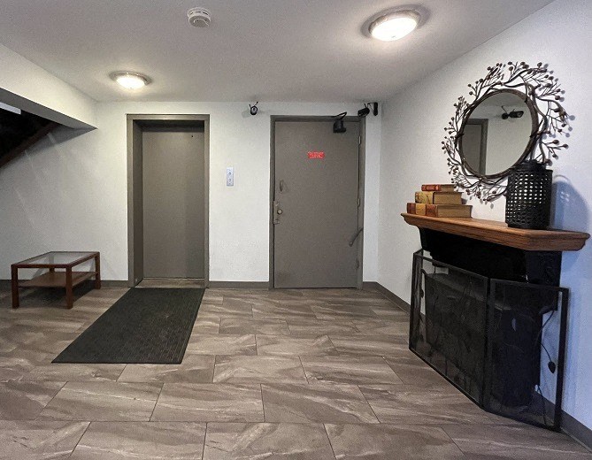 a lobby with a mirror and a door